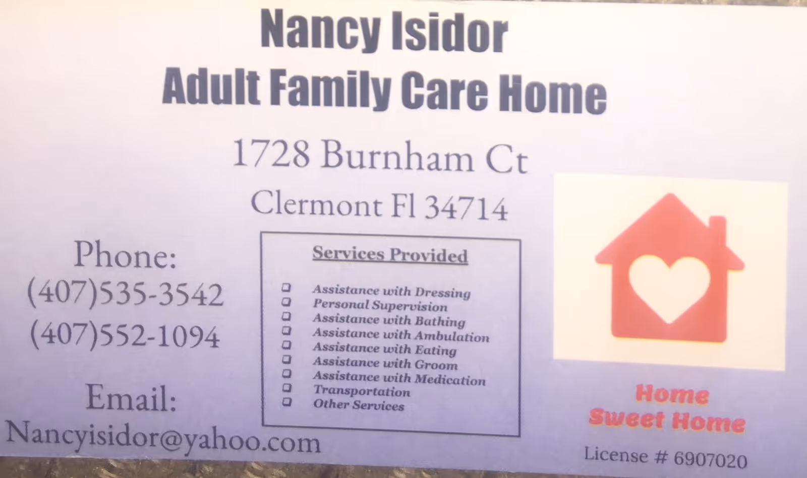 Sign for Nancy Isidor Adult Family Care Home with contact details and services.