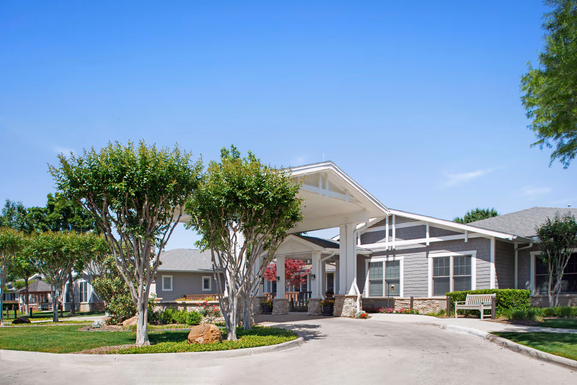 Exterior view of Sunrise of Fort Worth with front entrance canopy and landscaping.