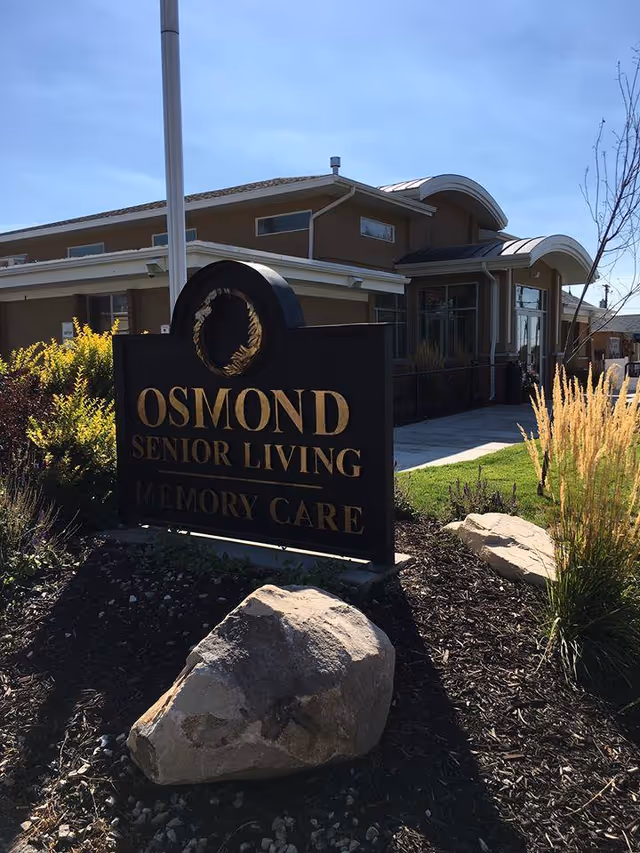 Exterior view of Osmond Senior Living Memory Care building with a large sign.