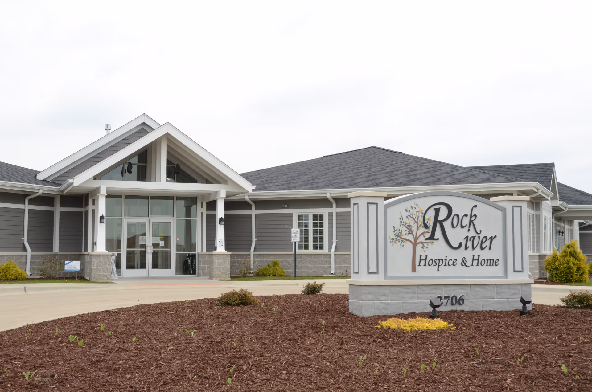 Exterior view of Rock River Hospice & Home with a large front sign.