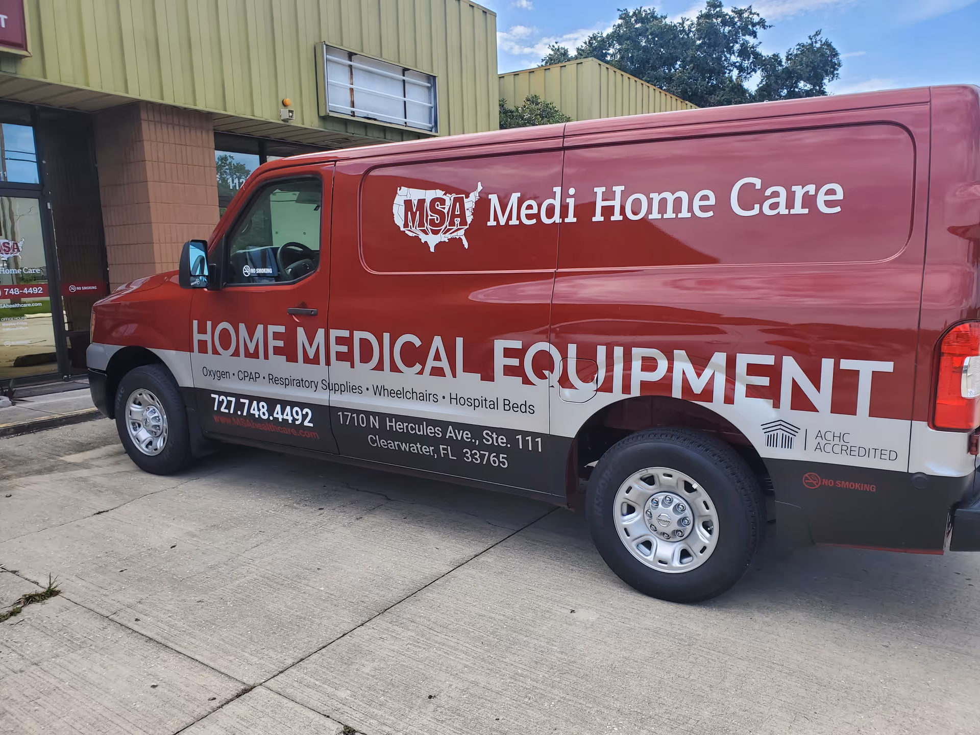 Red Medi Home Care van parked in front of a facility storefront