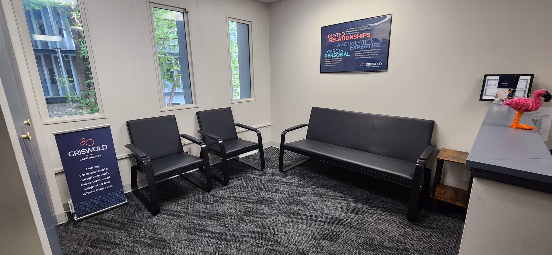 Griswold waiting area with black chairs, a gray couch, and a reception counter.