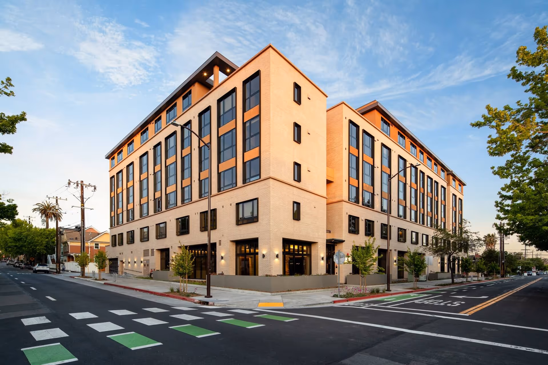 A modern multi-story senior living building on a corner street.