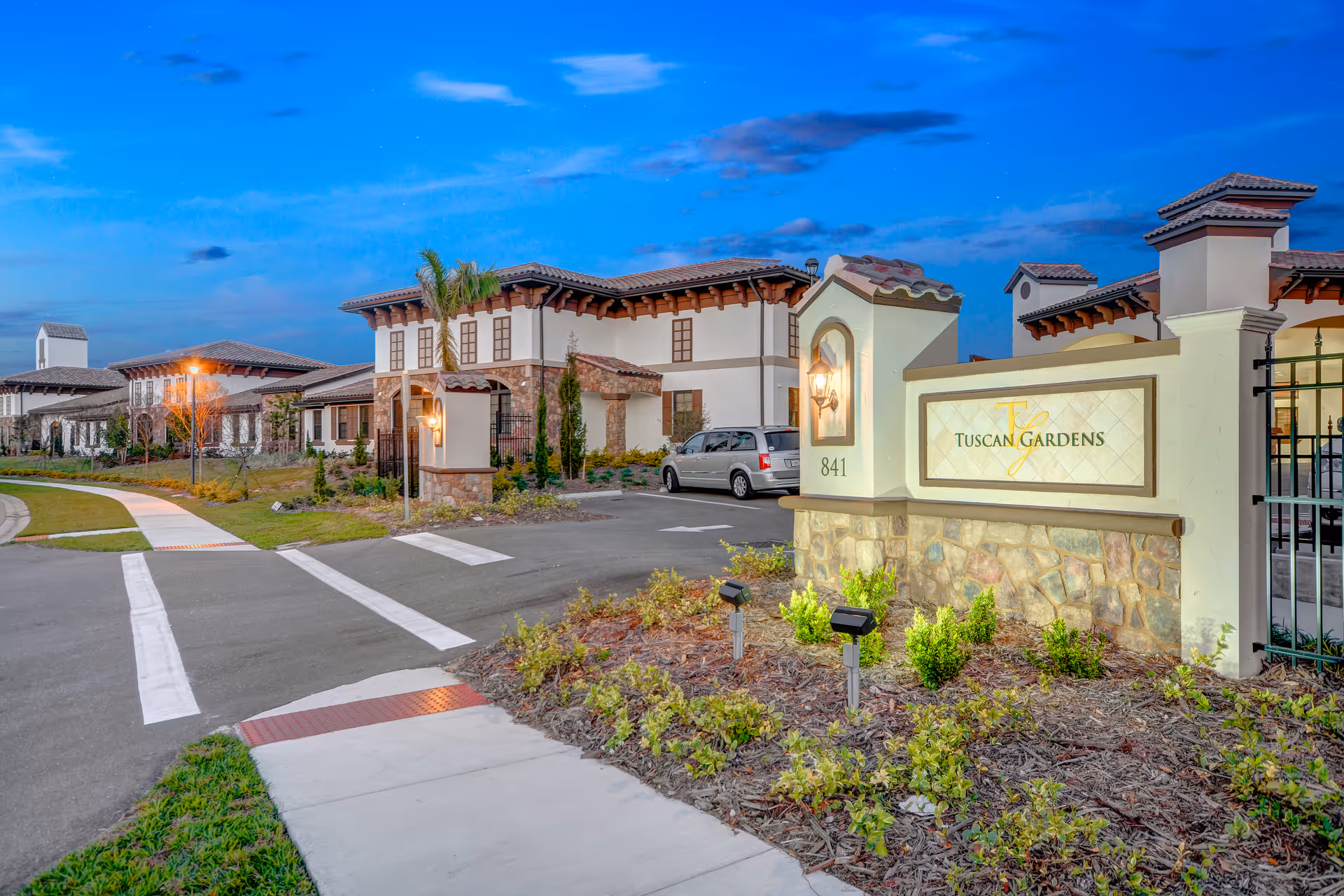 Exterior view of Tuscan Gardens of Venetia Bay Senior Living with entrance sign