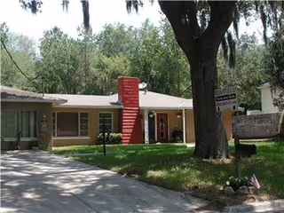 Pleasantville ALF exterior: single-story building with a red central staircase and green lawn
