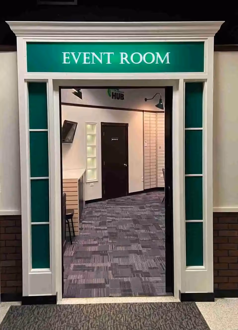 Interior doorway labeled Event Room with a teal framed entry and hallway beyond.