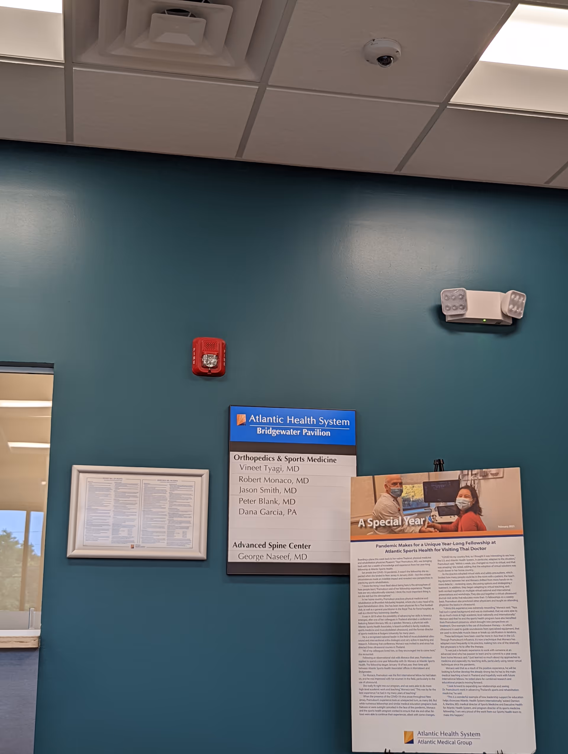 Teal wall interior with Atlantic Health System Bridgewater Pavilion sign and informational posters.