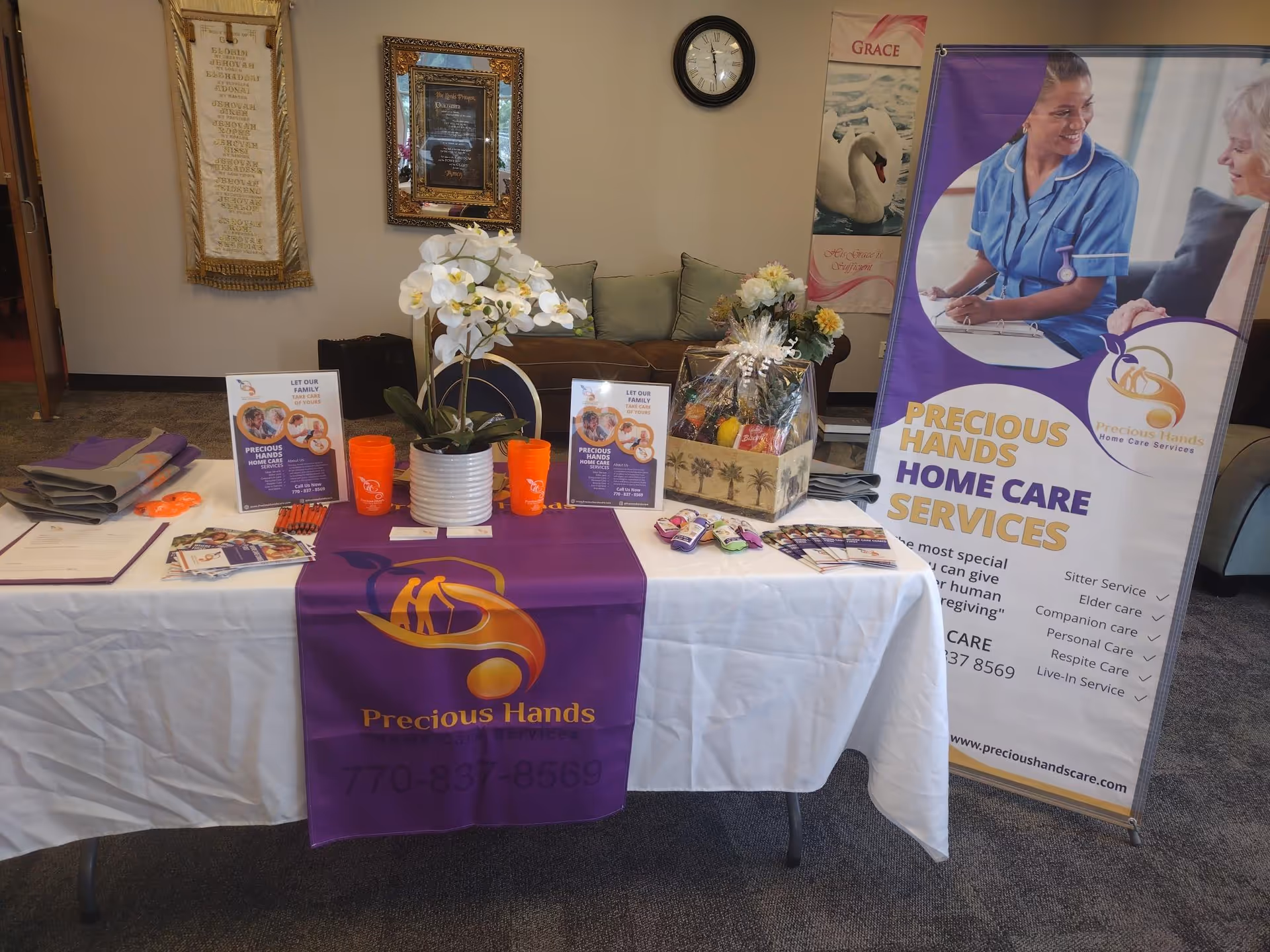 Promotional display with Precious Hands Home Care materials on a lobby table.