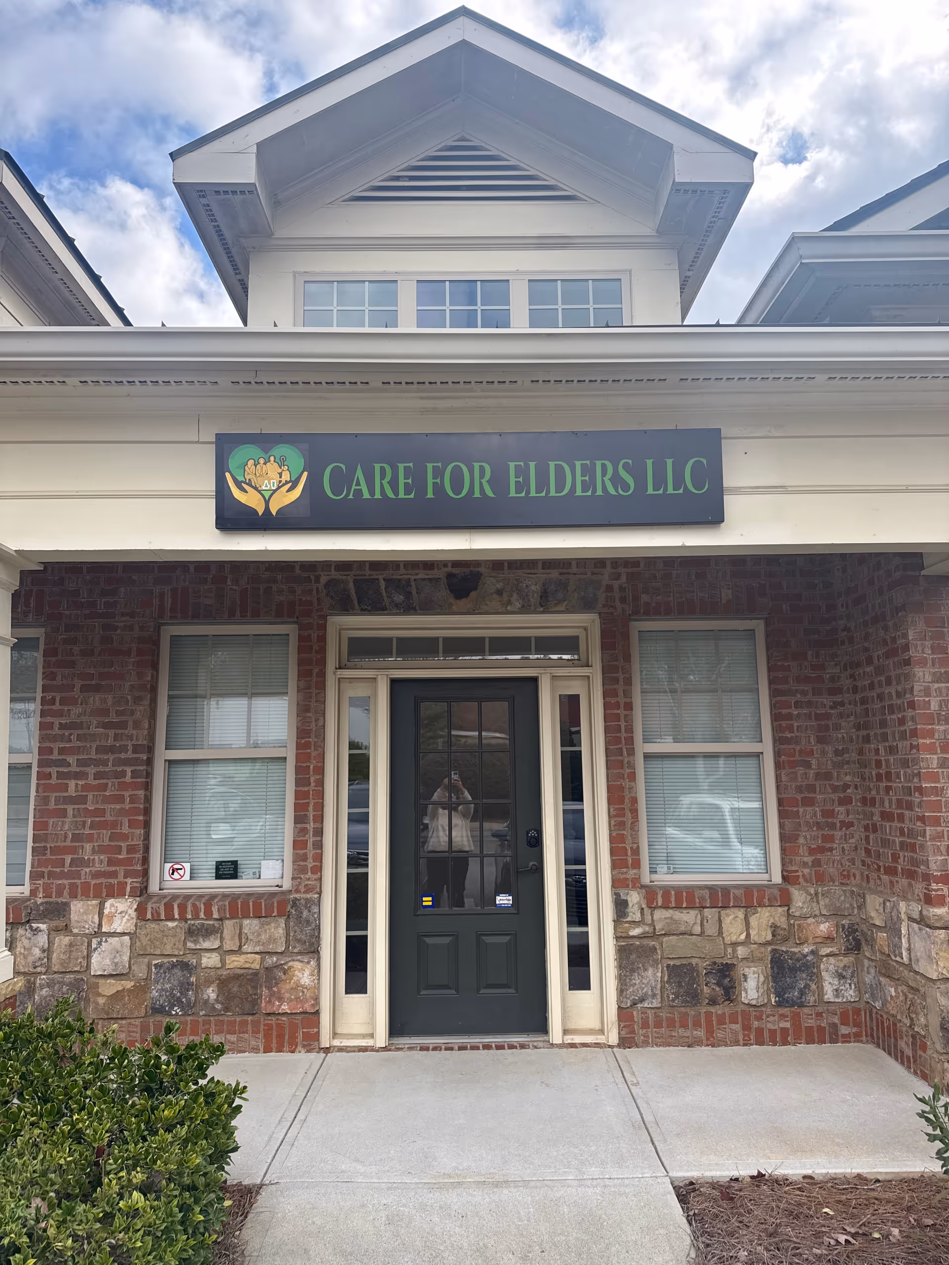 Exterior view of CARE FOR ELDERS LLC front entrance with brick walls and sign