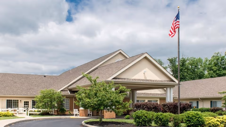 Front view of a Legacy Marion senior living facility entrance with a flag.