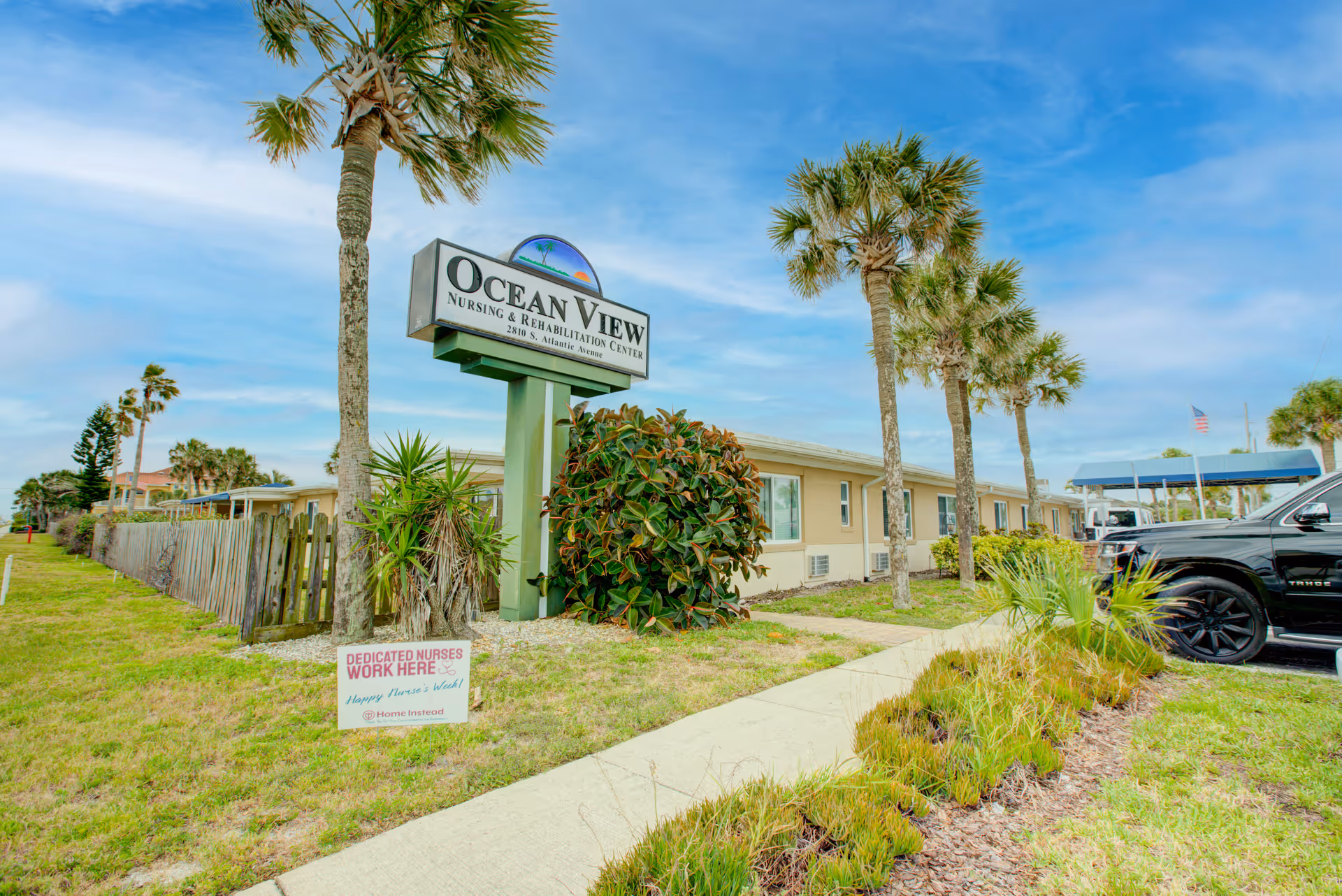 Exterior view of Ocean View Nursing & Rehabilitation Center with sign, palm trees, and parking.