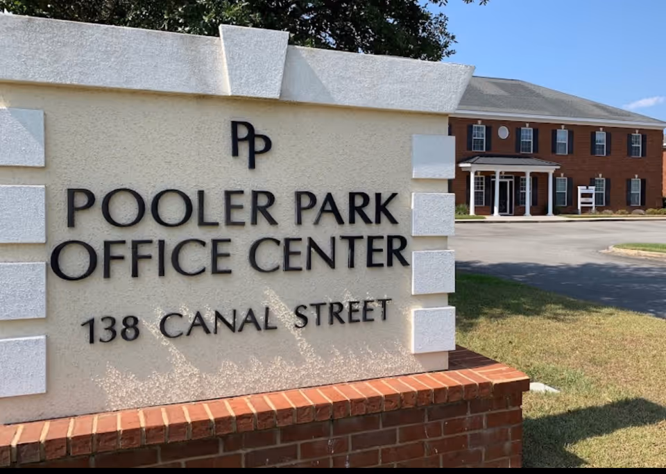 Front exterior sign reads Pooler Park Office Center, brick building in background.