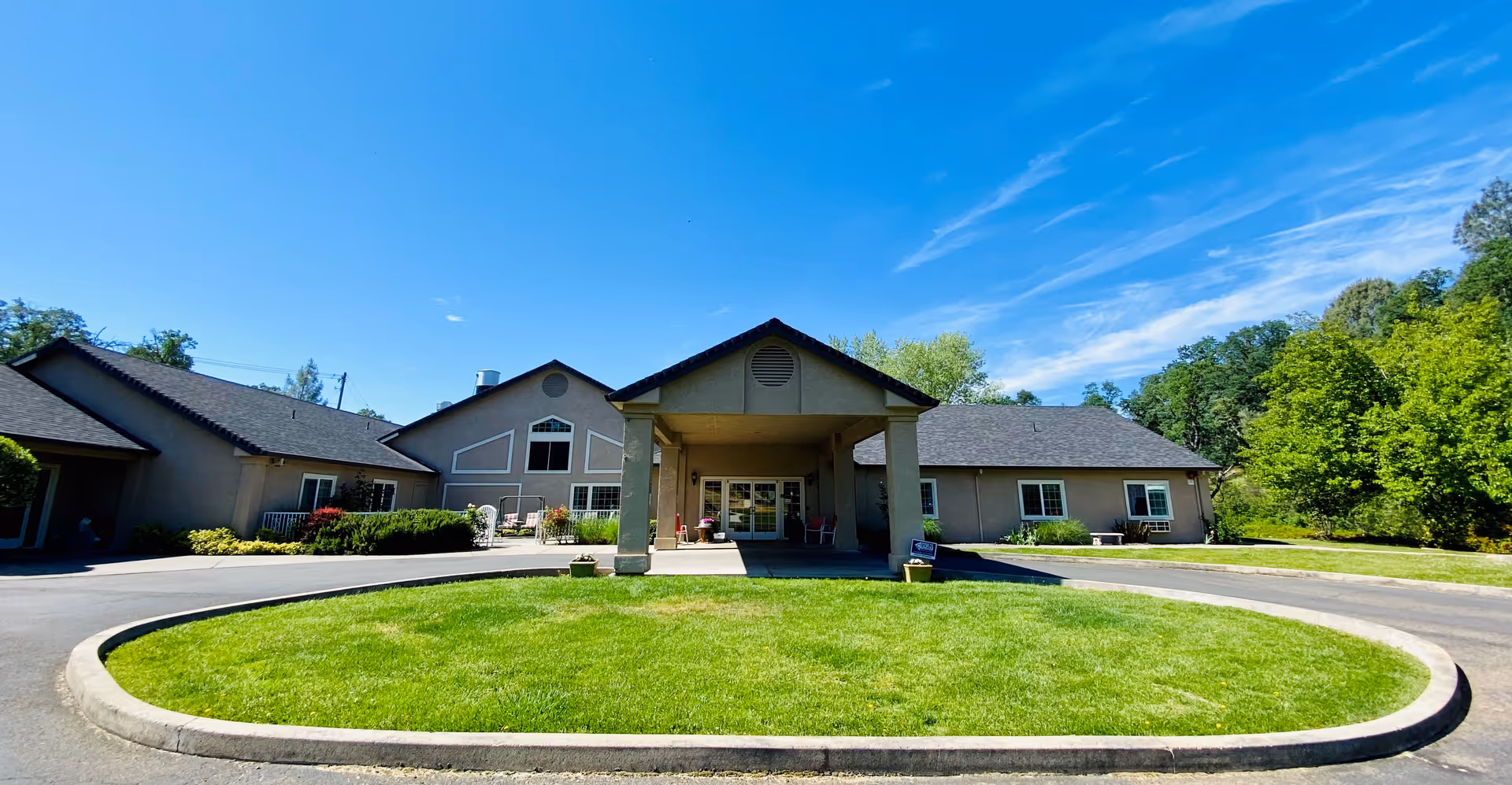 Front view of Sierra Oaks Assisted Living & Memory Care building with circular driveway and lawn.