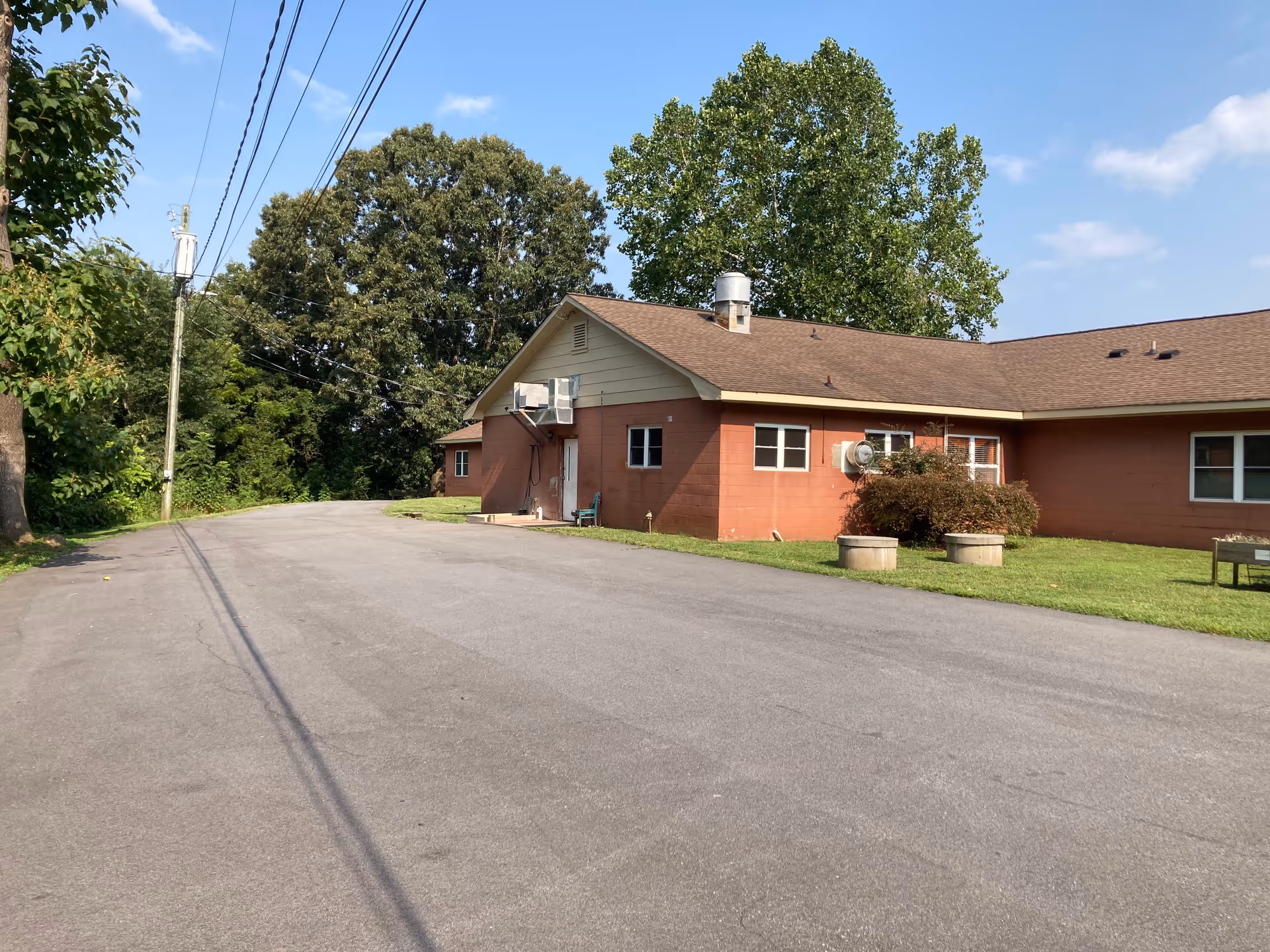 Exterior view of Heritage Care Home of Taylorsville with driveway and trees