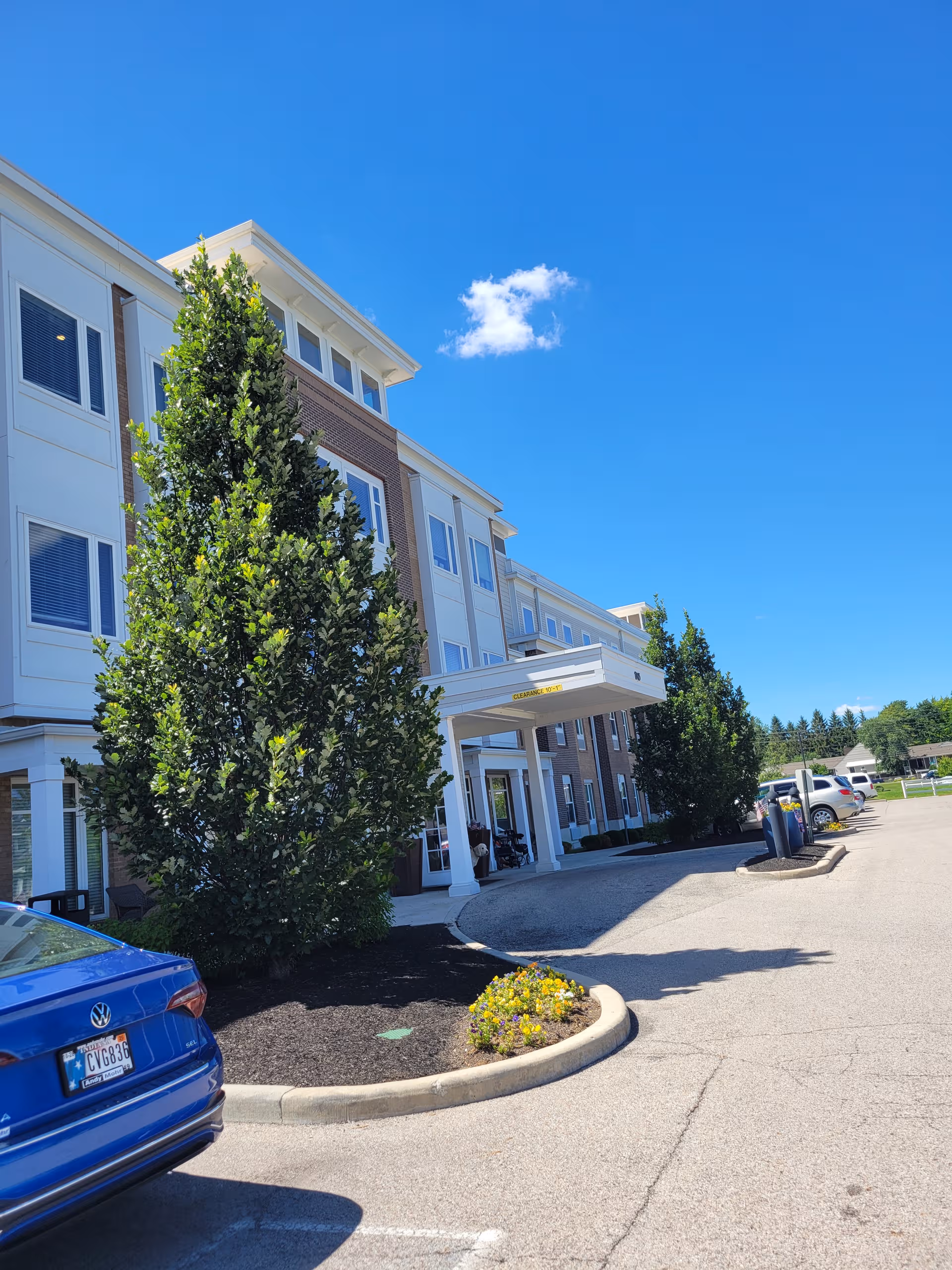 Exterior view of Traditions at North Willow, a multi-story senior living facility entrance.