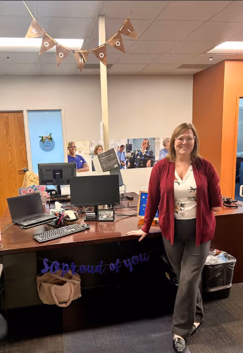 Reception desk with computers and staff inside Maxim Healthcare Rockford Regional Office.