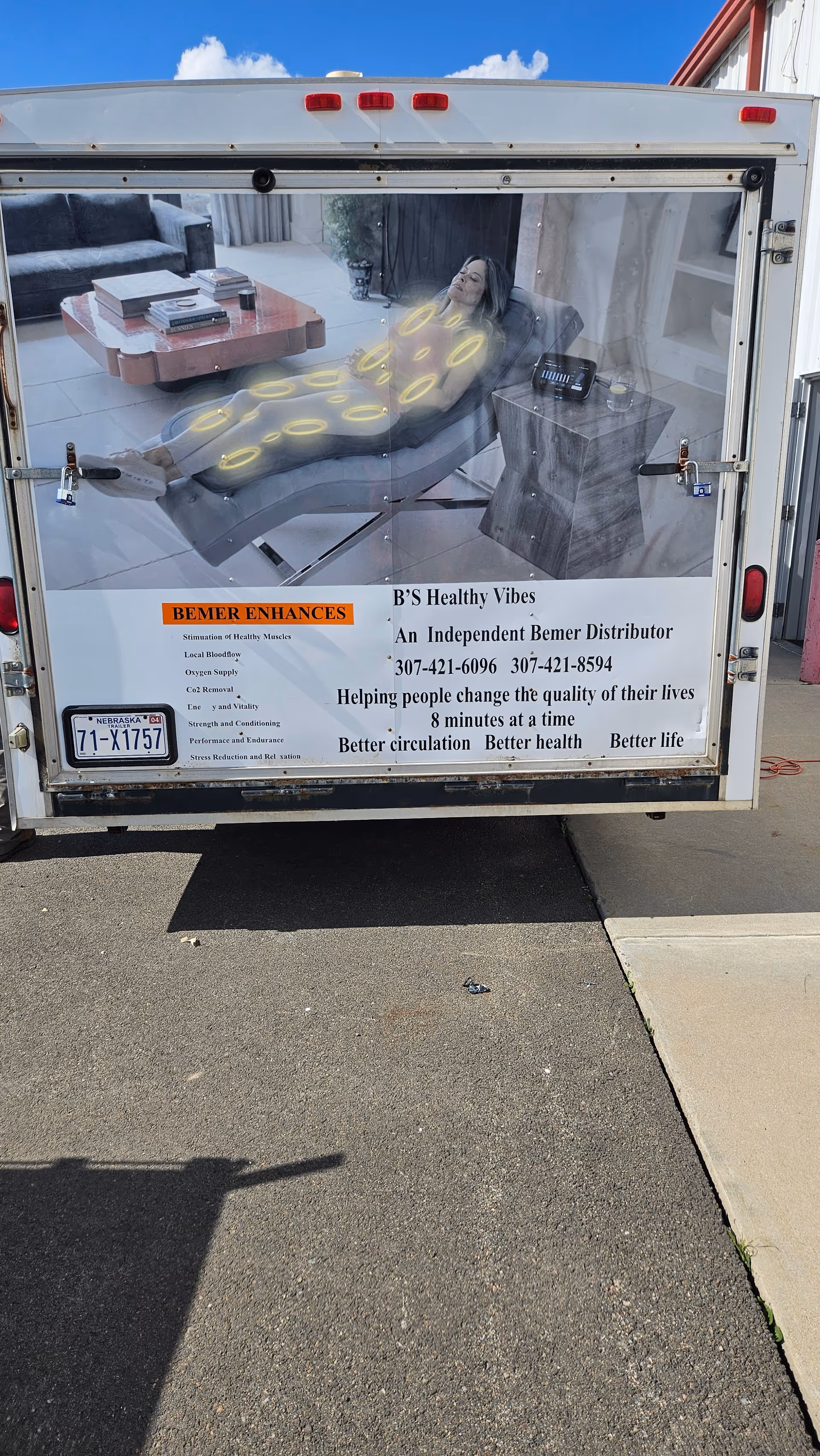 Back of a B's Healthy Vibes promotional trailer showing a person on a treatment bed.