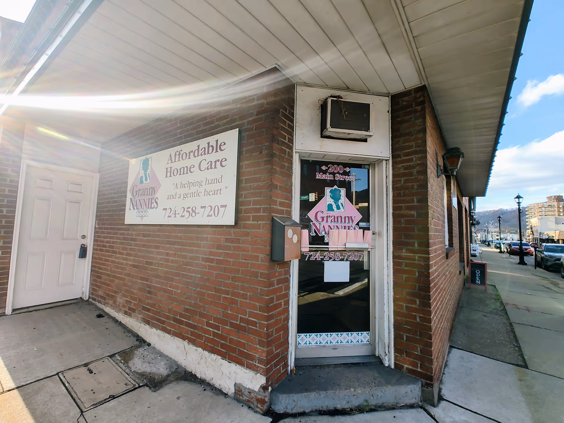 Brick building exterior featuring Granny NANNIES sign and storefront entrance.