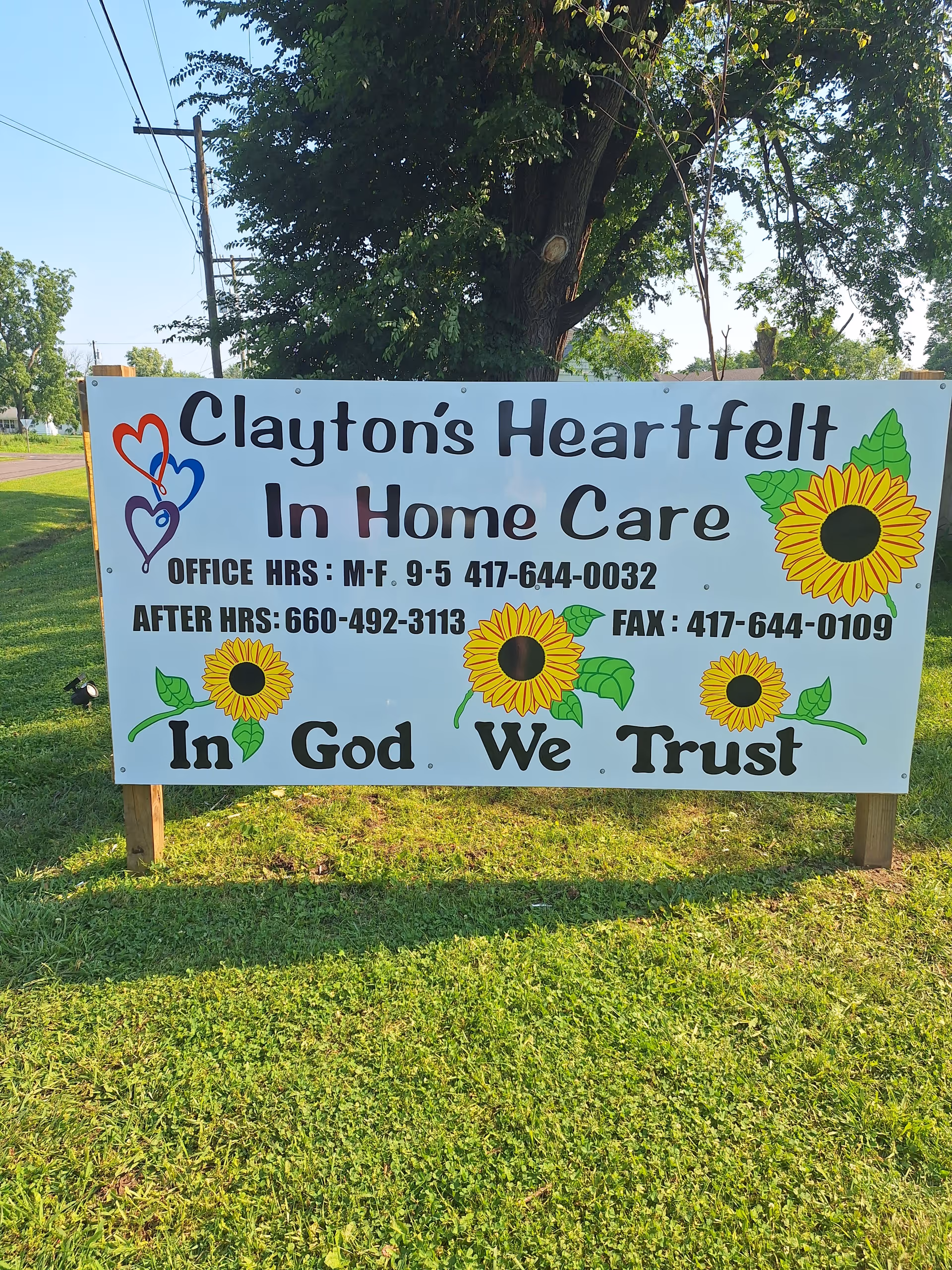 Large outdoor sign for Clayton's Heartfelt In Home Care with sunflowers on grass