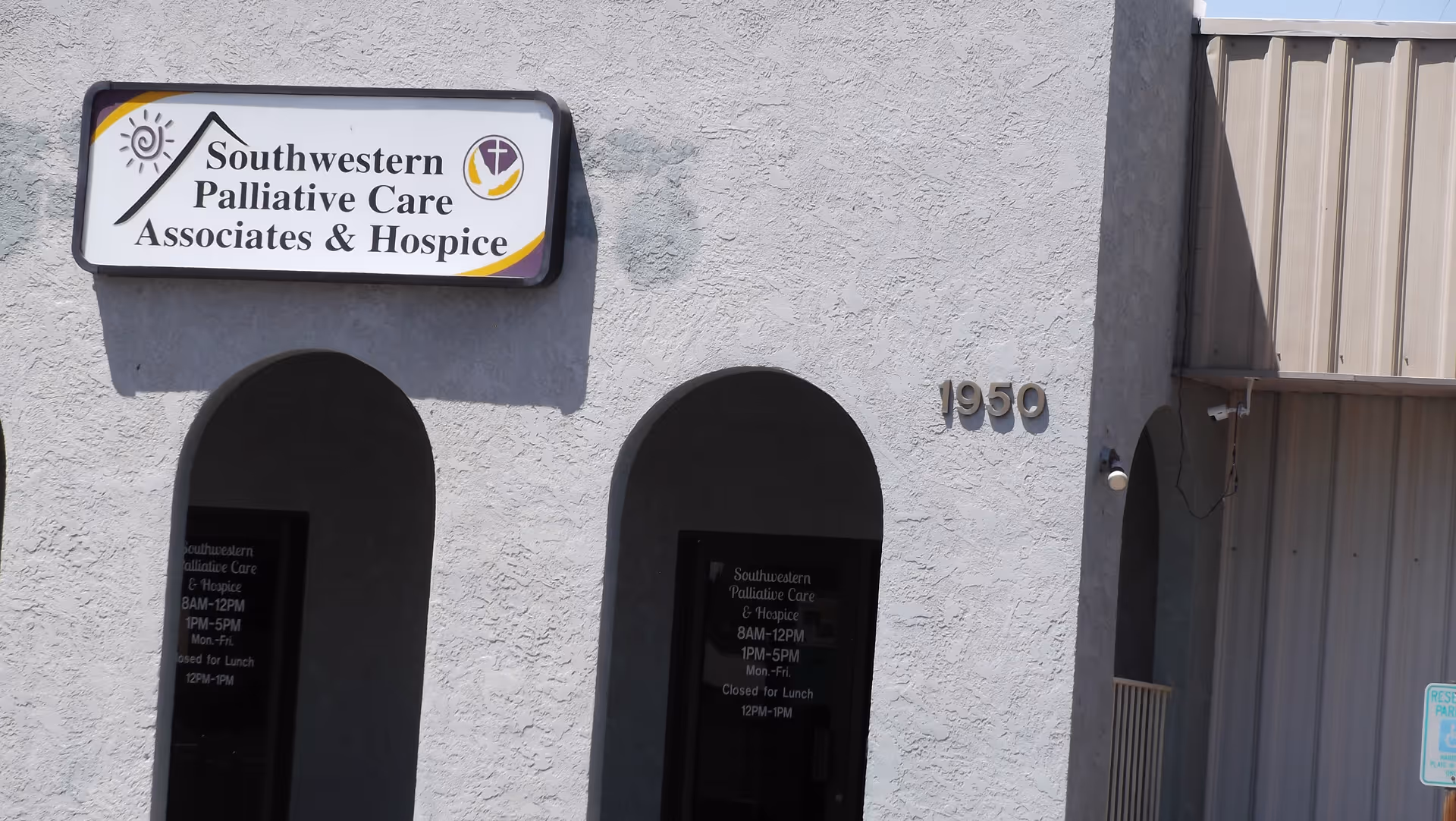 Exterior view of Southwestern Palliative Care and Hospice building with sign and arched entrance.