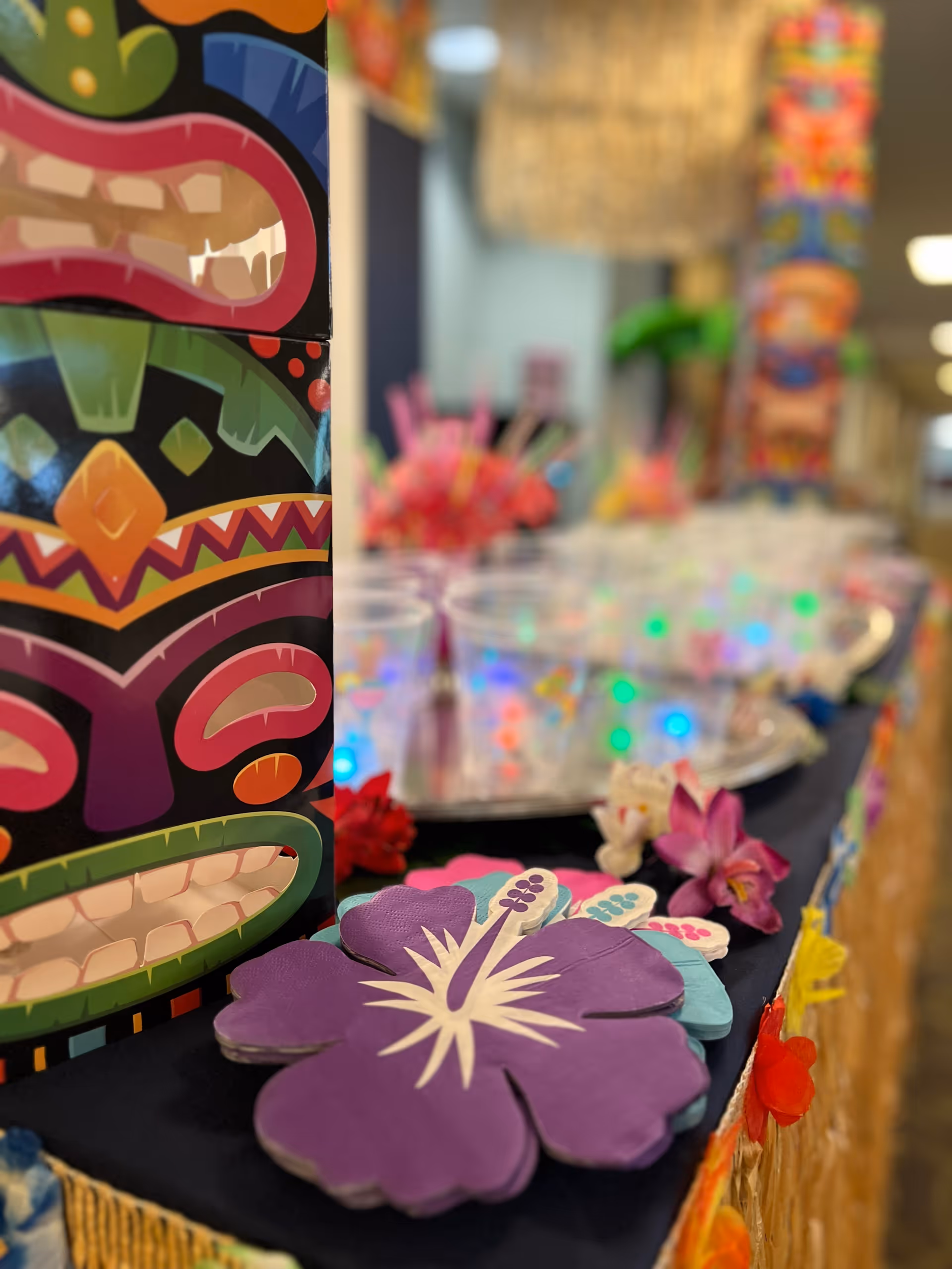 Close-up of vibrant party decorations on a table at a senior living facility.
