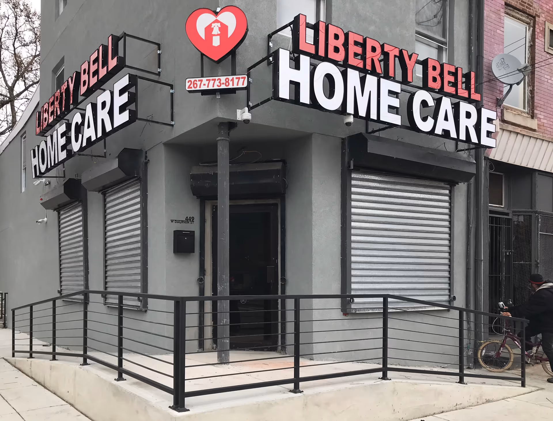 Corner storefront displaying Liberty Bell Home Care signage with ramp and shutters.