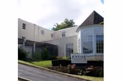 Exterior view of Envoy of Staunton senior living facility with front sign.