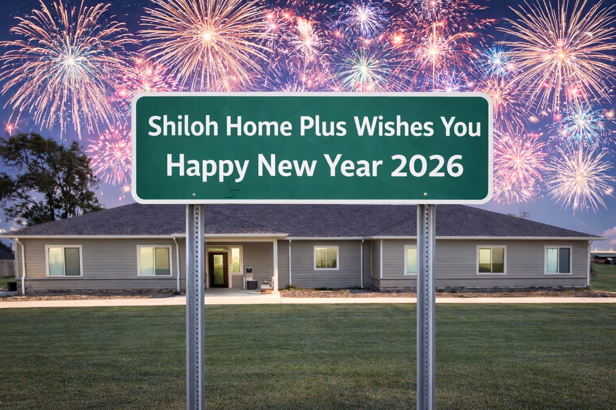 Single-story building with a large green sign and fireworks overhead.