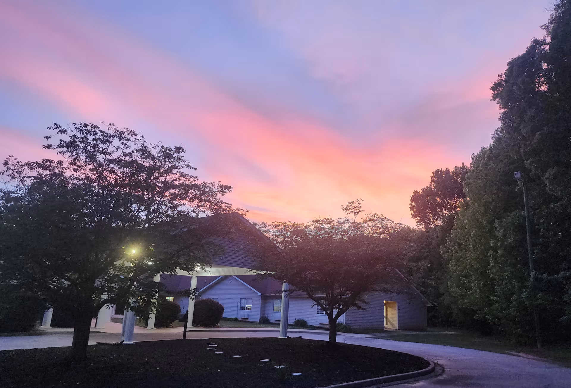 Twilight sky over Brookstone Terrace of Woodruff exterior with entrance and trees.
