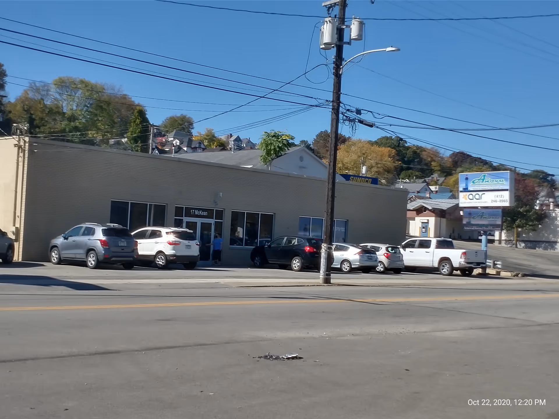 Exterior view of Anova Health Care System building with cars parked in front.