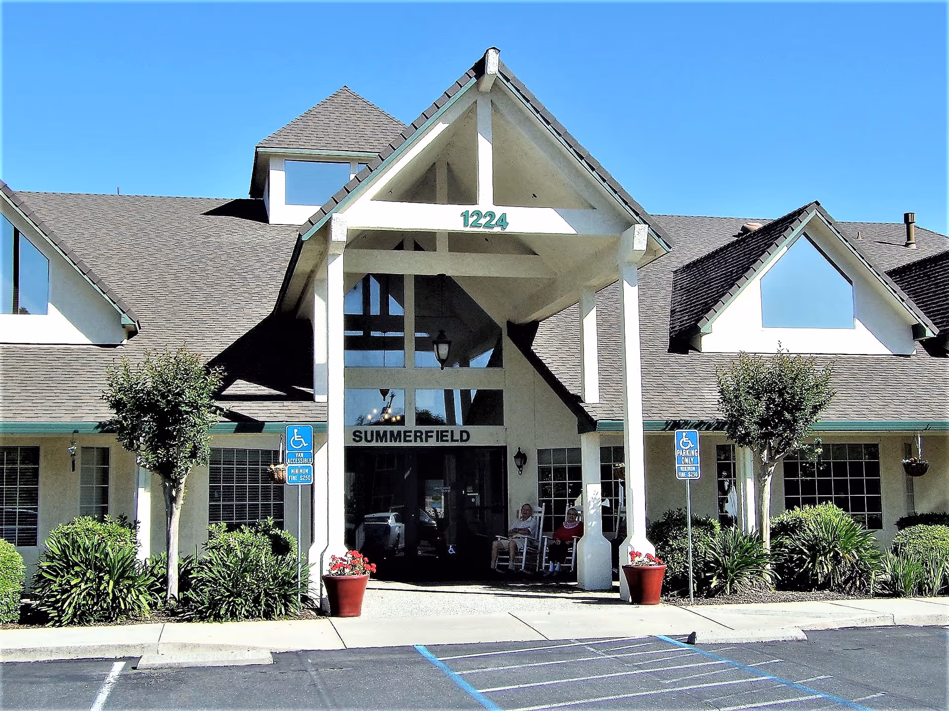 Front view of Summerfield Senior Living building with entrance and handicap parking.