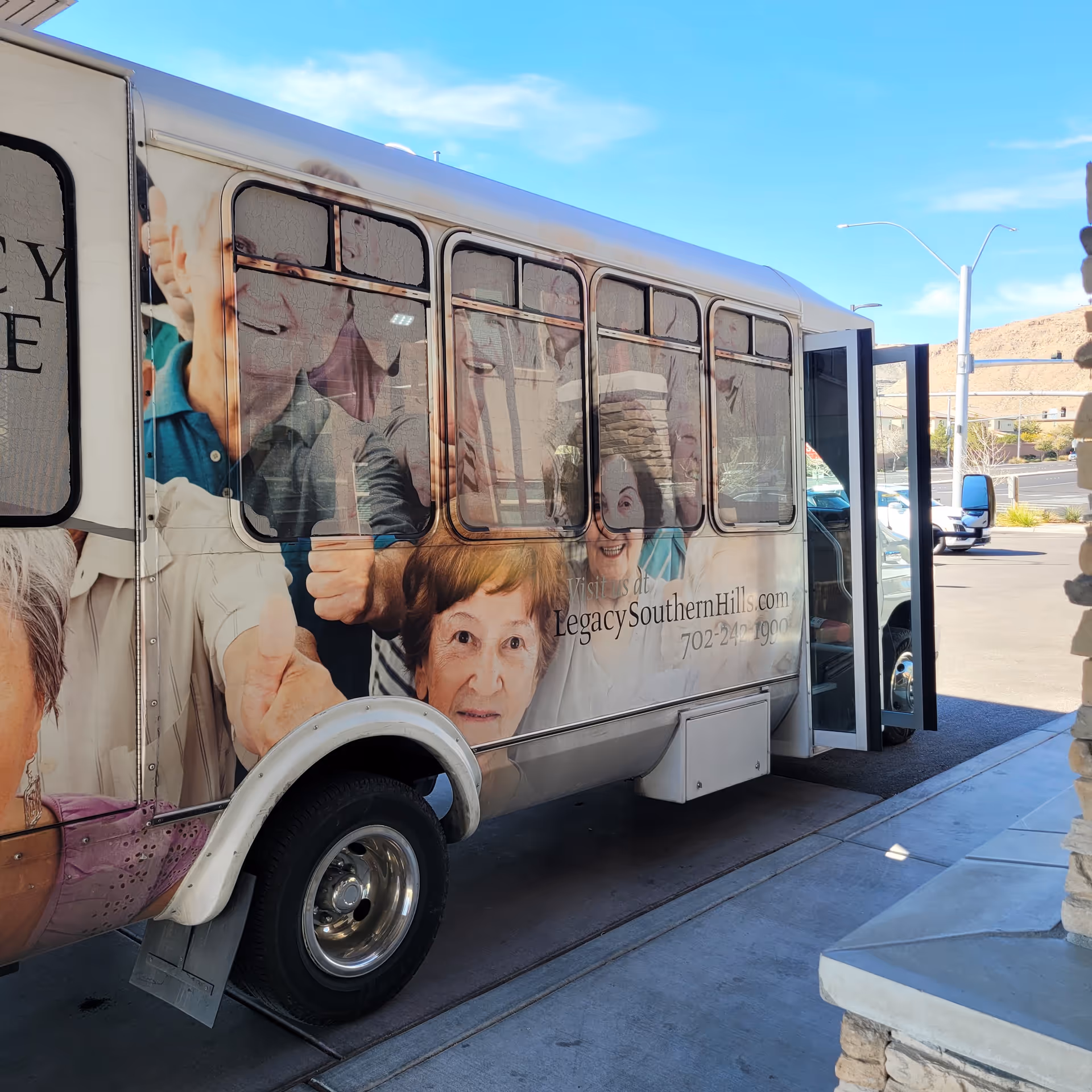 A bus wrapped with seniors' images parked outside Legacy House of Southern Hills.