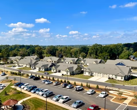Aerial view of Friends Homes West exterior campus with parked cars and greenery.