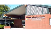 Exterior view of Crescent Health Care building with brick facade and covered entrance.