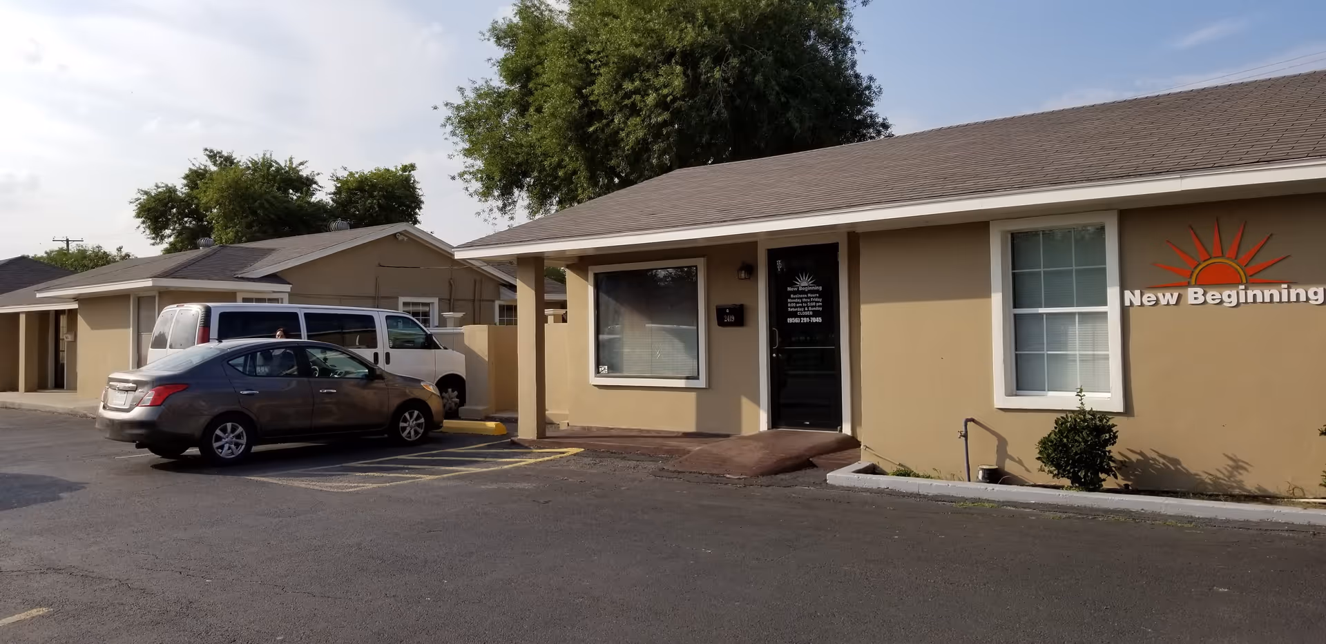Exterior view of New Beginning HCSP LLC facility with parked cars by entrance.