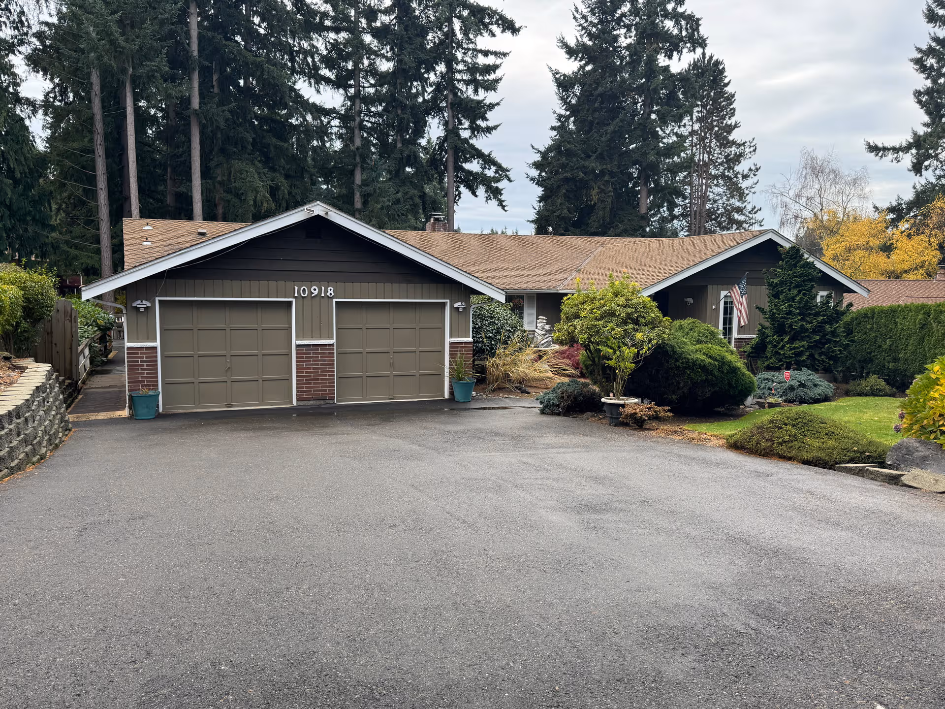 A single-story senior living home with two garage doors and manicured front yard.