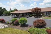 Shady Nook Care Center: a single-story facility with a covered entrance, parking, and shrubs.