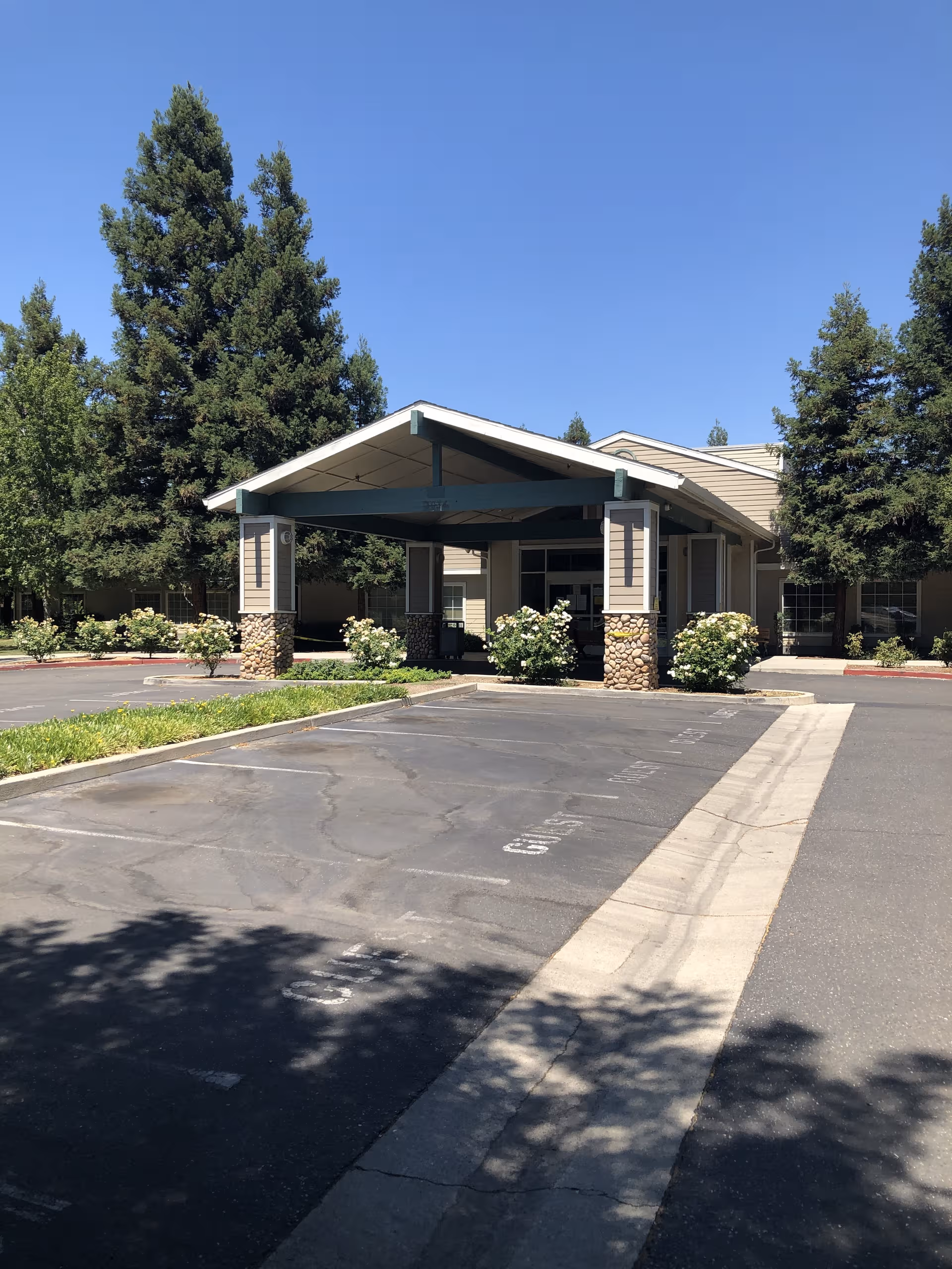 Front entrance of Horizon Health & Subacute Center with porte-cochere and trees