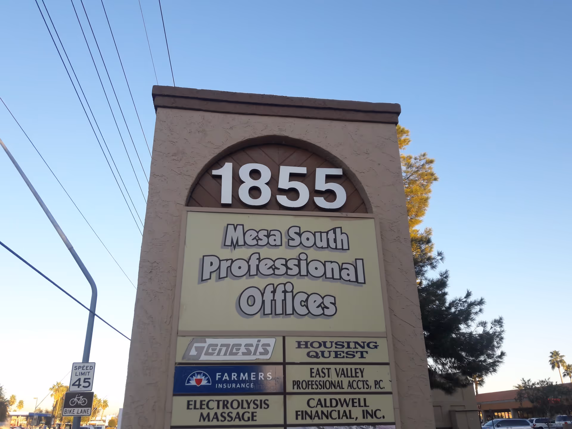 Tall beige outdoor sign reads 1855 and Mesa South Professional Offices under a clear sky