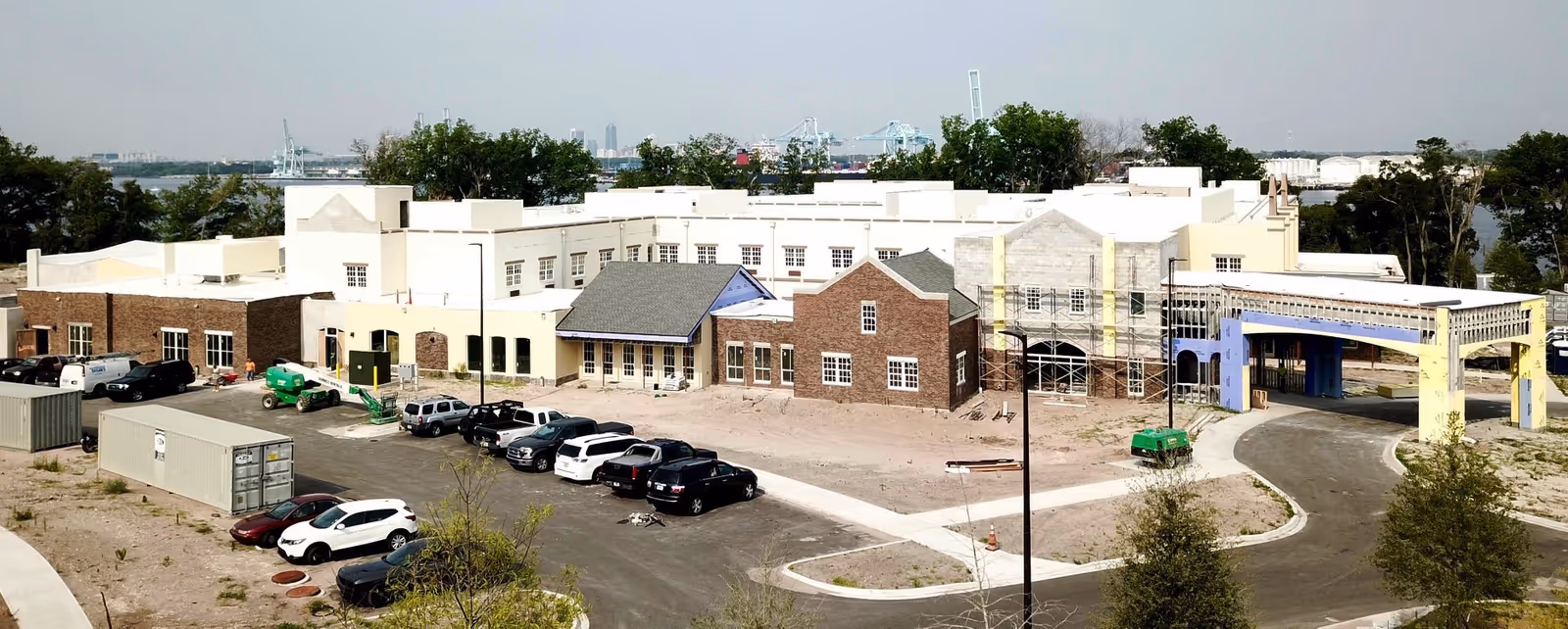 Exterior view of Dolphin Pointe Health Care under construction with parked cars.