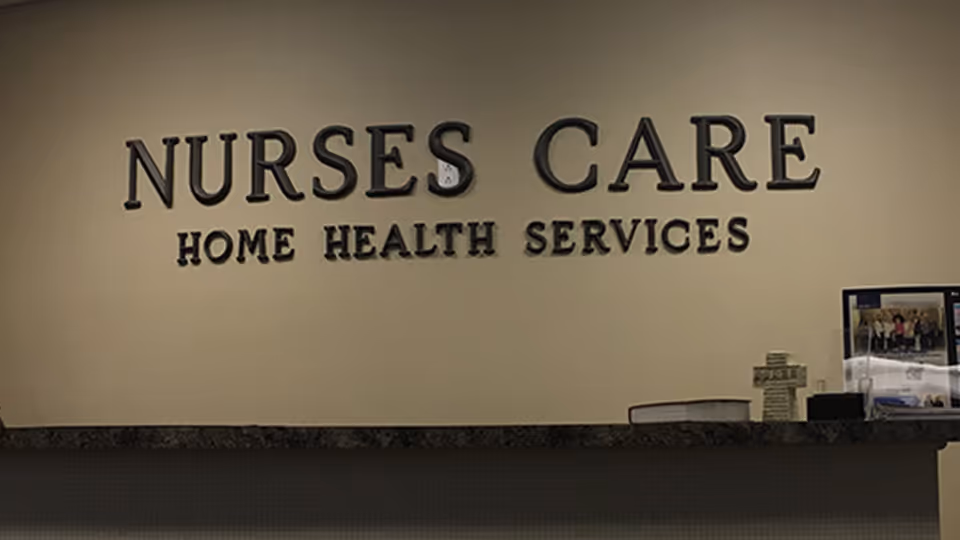 Interior reception area with a large 'NURSES CARE' sign on the wall.