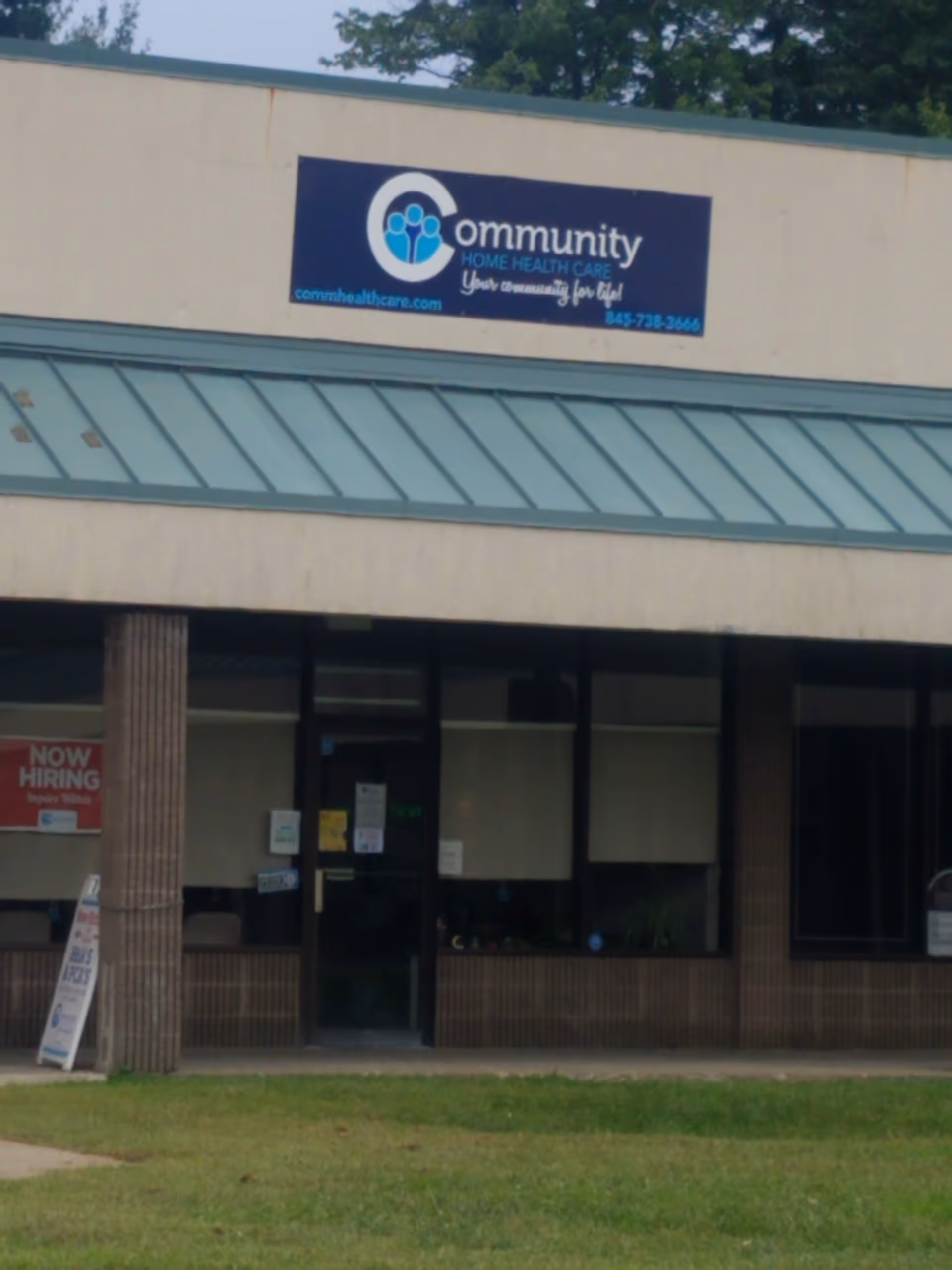 Front exterior of a building with a Community Home Health Care recruiting office sign.