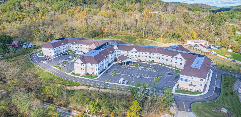 Aerial view of Harmony at Harts Run senior living campus surrounded by trees.