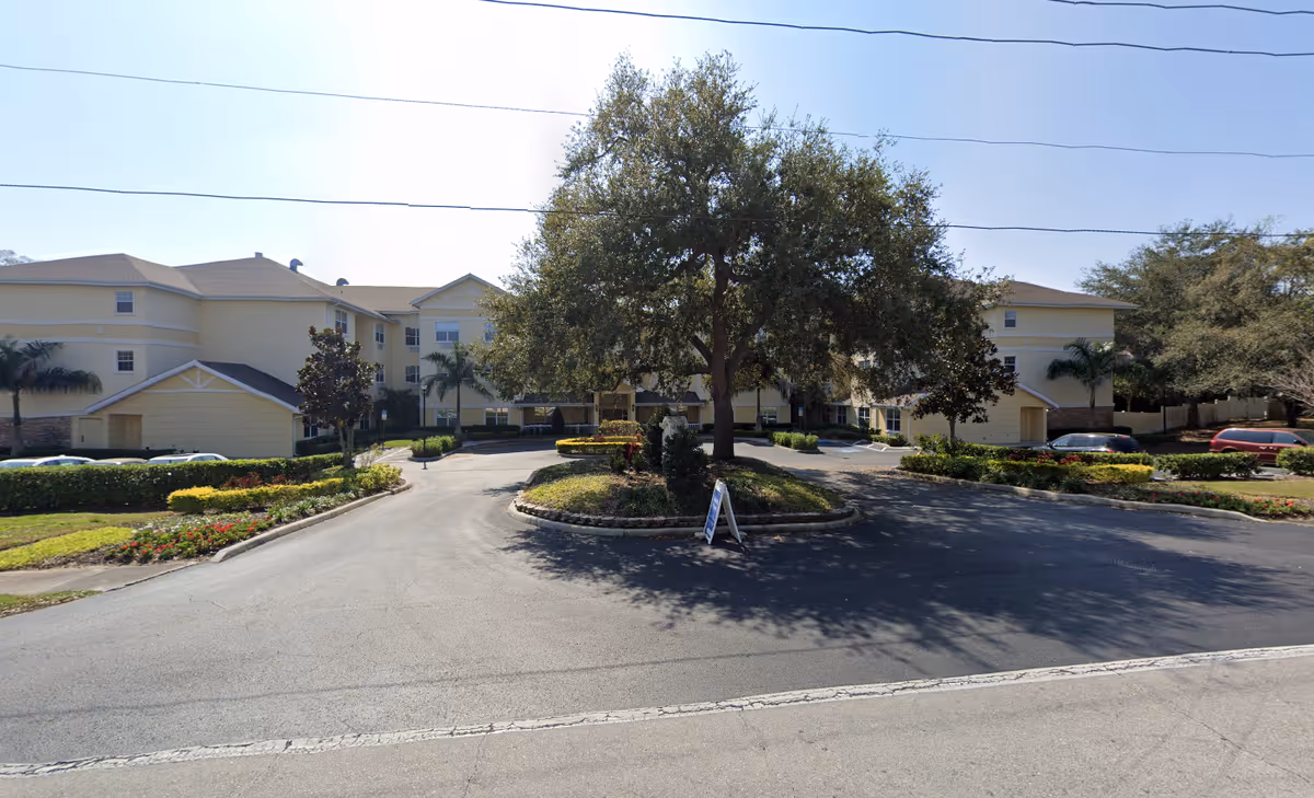 Exterior view of The Colonnade at Beckett Lake with circular drive and landscaped grounds.