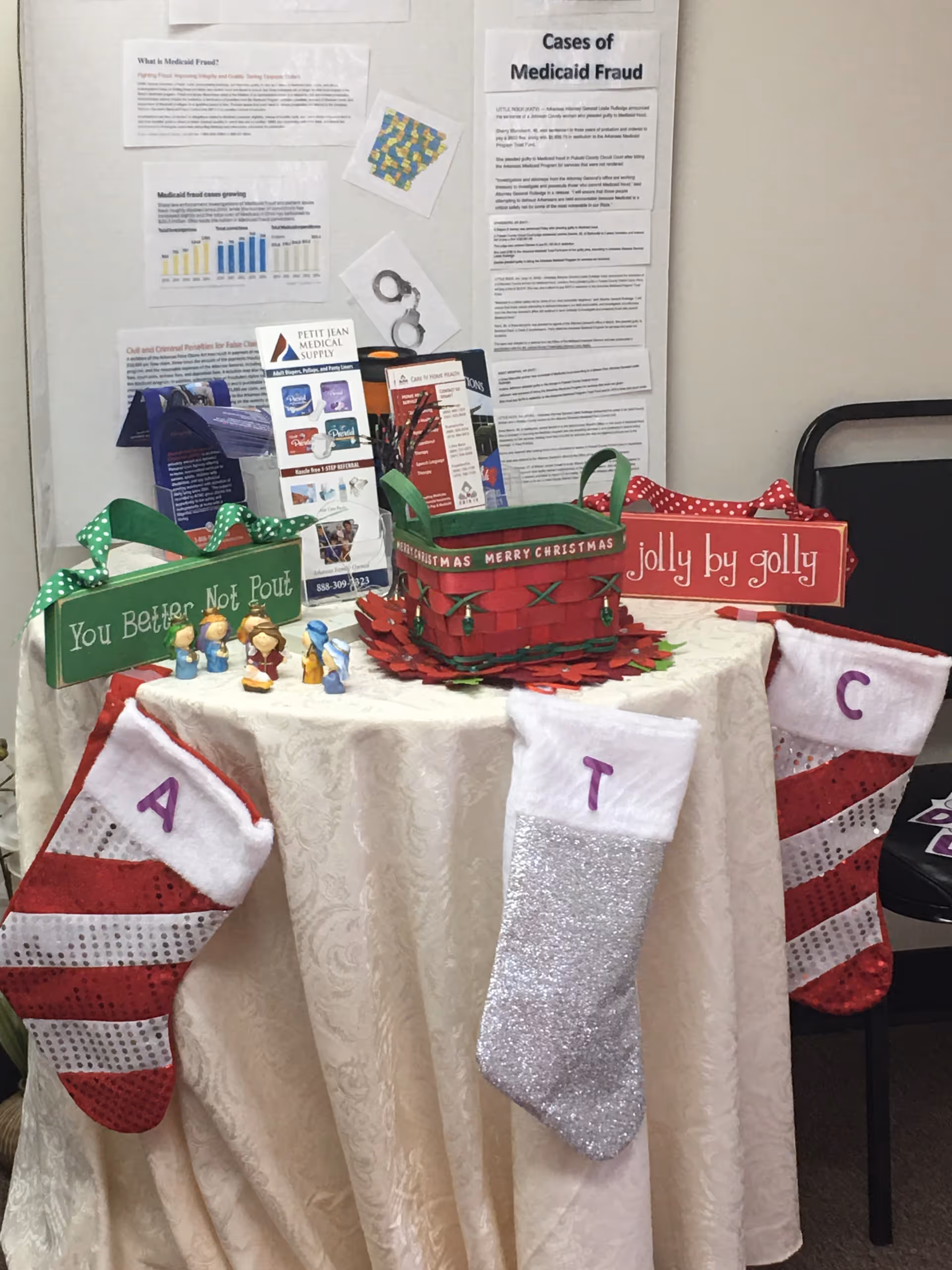 Table with Christmas stockings and gift baskets on display inside an indoor facility.