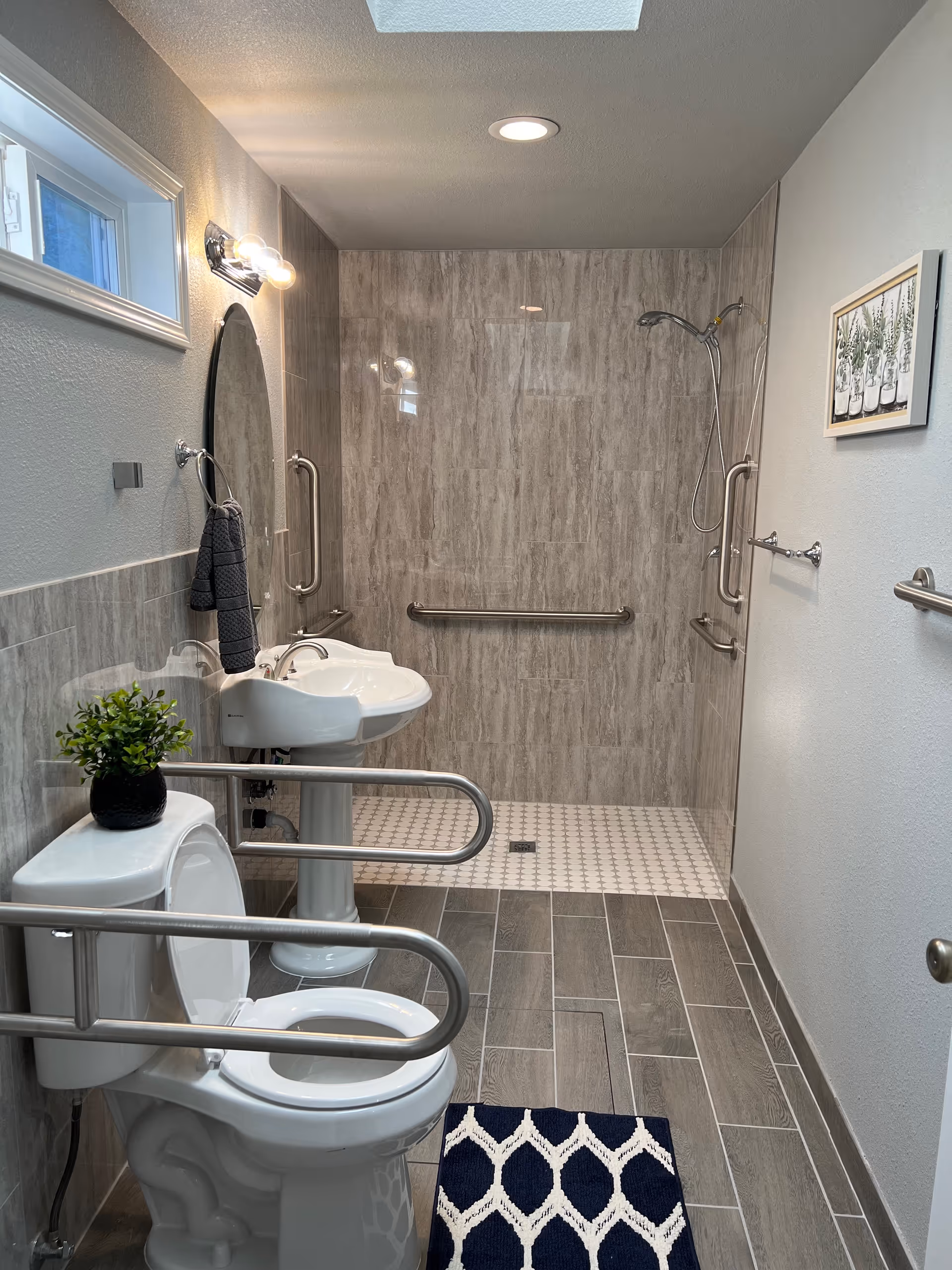 Accessible bathroom with walk-in shower, grab bars, and ADA fixtures.