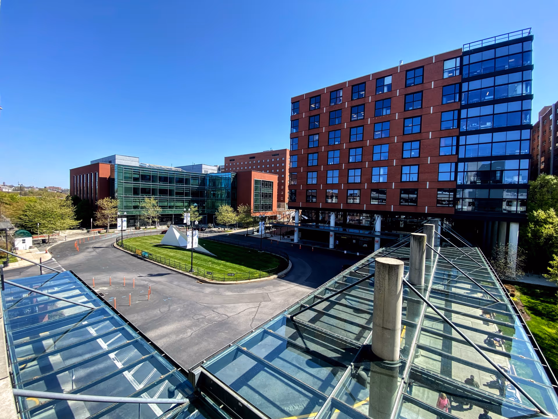 Wide view of Johns Hopkins Outpatient Center campus with glass walkways and brick buildings.