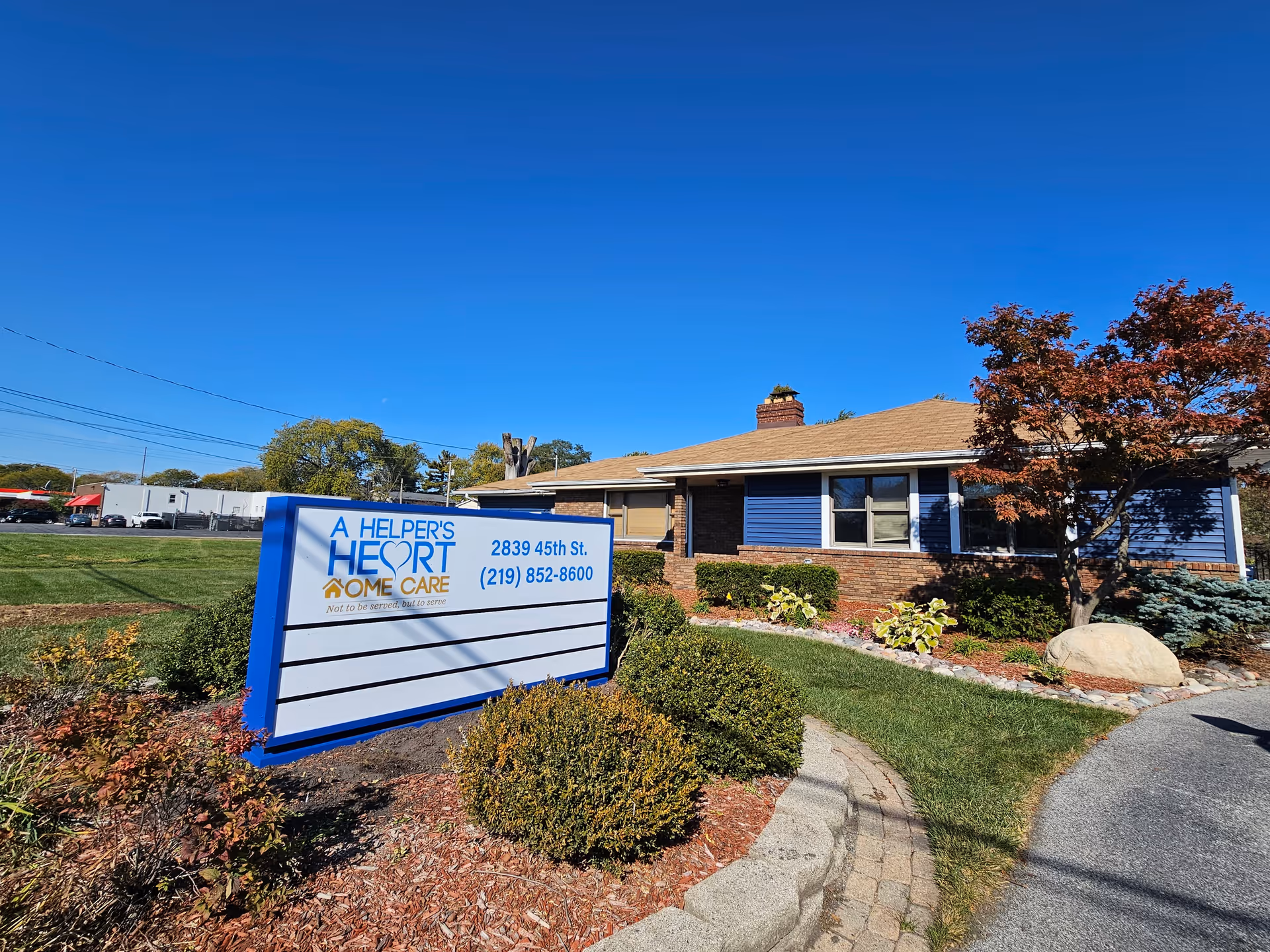 Exterior view of A Helper's Heart Home Care building with a blue sign.