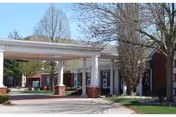 Front view of Pekin Estates entrance with a covered driveway and columns.