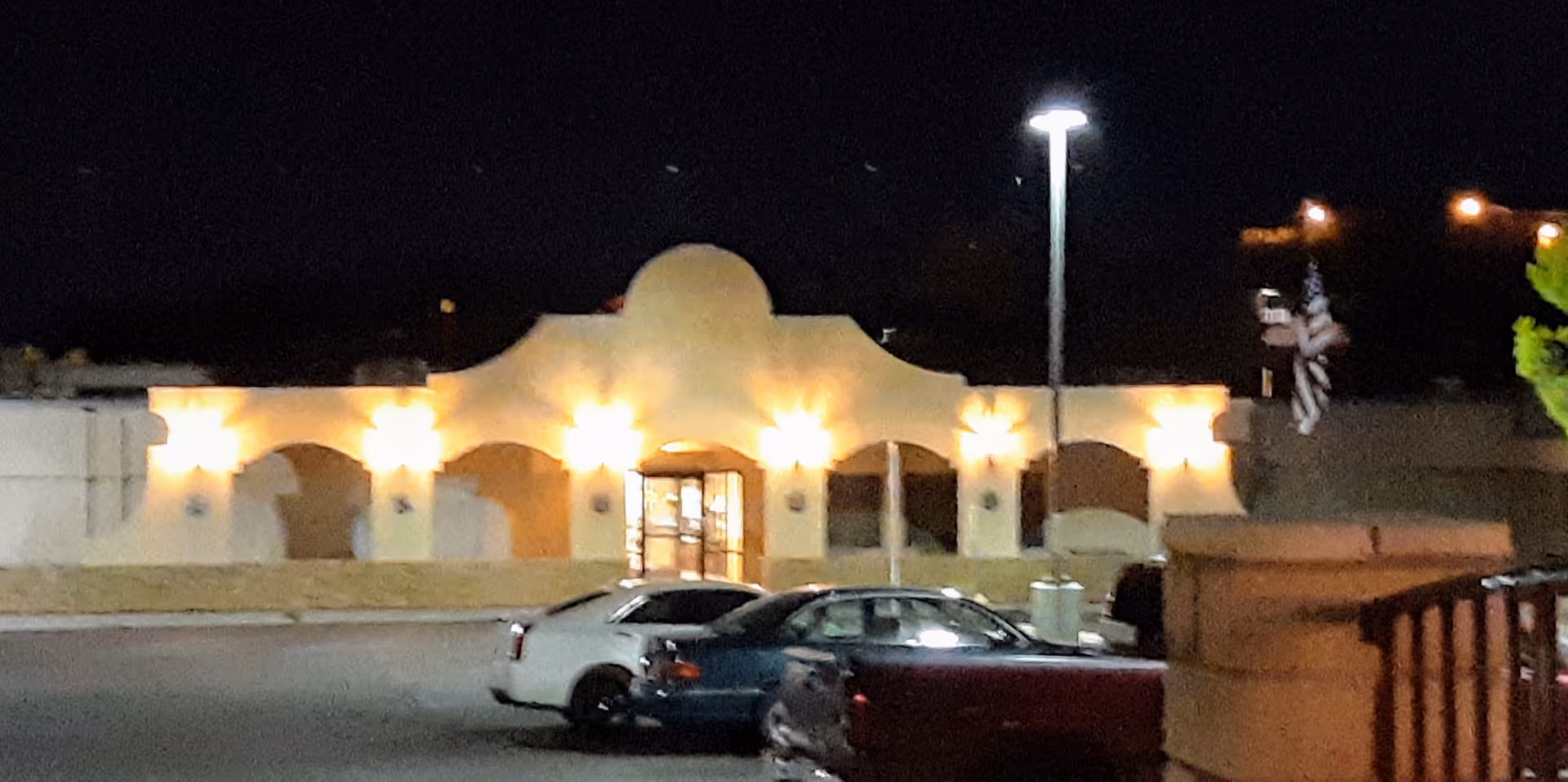 Night view of Mountain View Care Center exterior with parked cars in front.